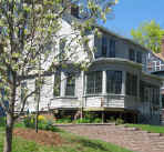 Picture of 75 Kenyon: Grey shingle bungalo w/ tree in bloom