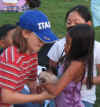Kids handing off Mishu, the cat