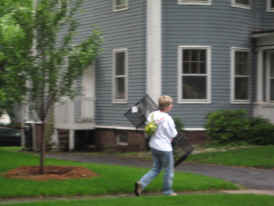 Woman walking down Kenyon Street with shelving