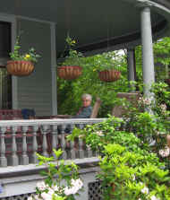 Relaxing on the porch with three hanging baskets