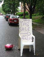 A hand lettered sign announces the Kenyon Street Tag Sale