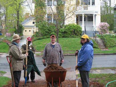 Neighbors hauling mulch - fabulous home in the background